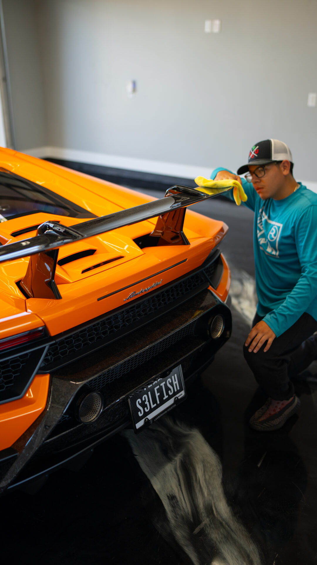 Detailer working on an exotic car