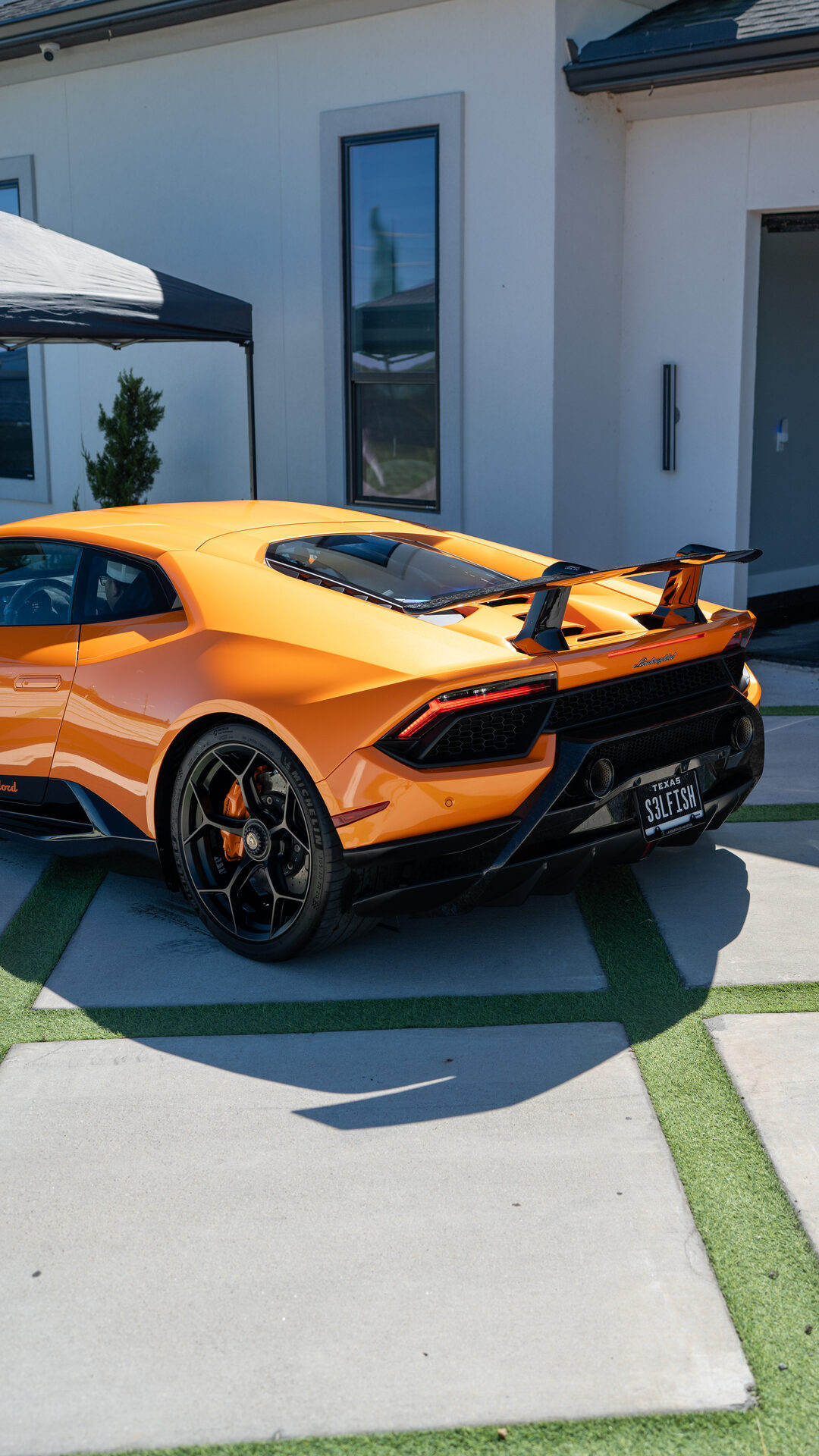 Detailed exotic car in a driveway