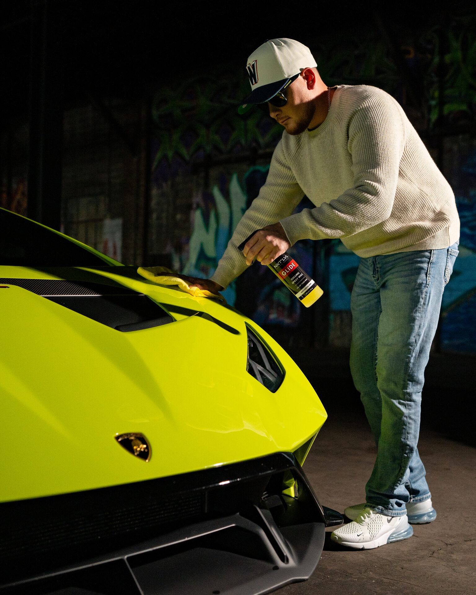 Detailer applying product to a yellow exotic